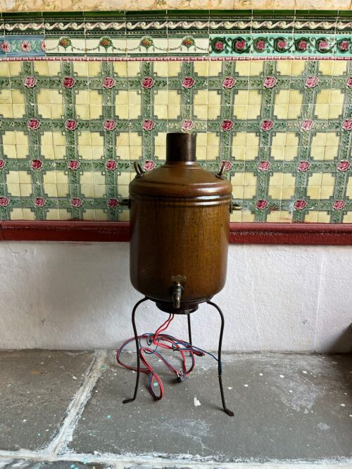 Antique copper hot water heater with iron stand