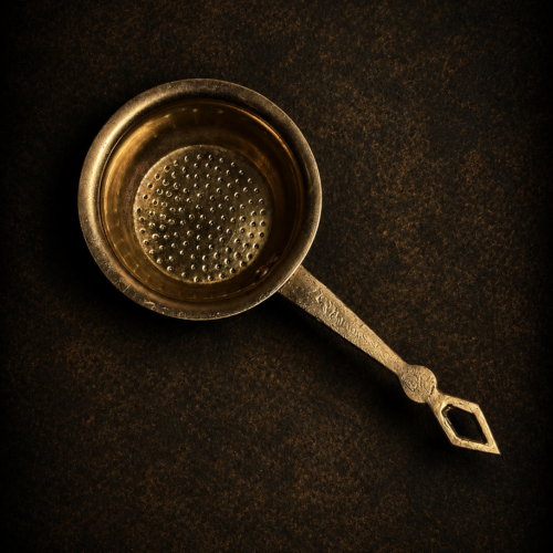 Vintage brass tea strainer
