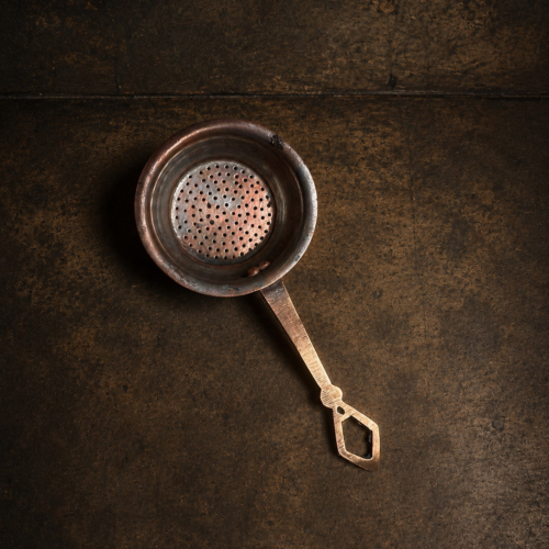 Vintage brass tea strainer