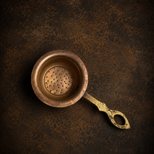 Vintage brass tea strainer