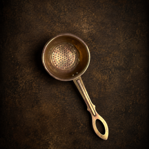 Vintage brass tea strainer